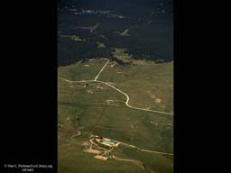 Urban sprawl reaching into forest (aerial), Western USA