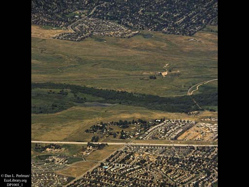Urbanization closing in on river (aerial), Western USA